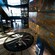 The spacious atrium of Titanic Belfast reveals multiple floors, escalators and a mosaic of a compass on the floor